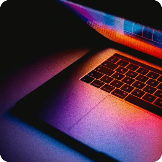 Laptop lit with colourful light
